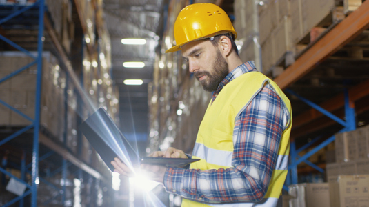 Warehouse manager reviewing fleet performance data from fleet insights
